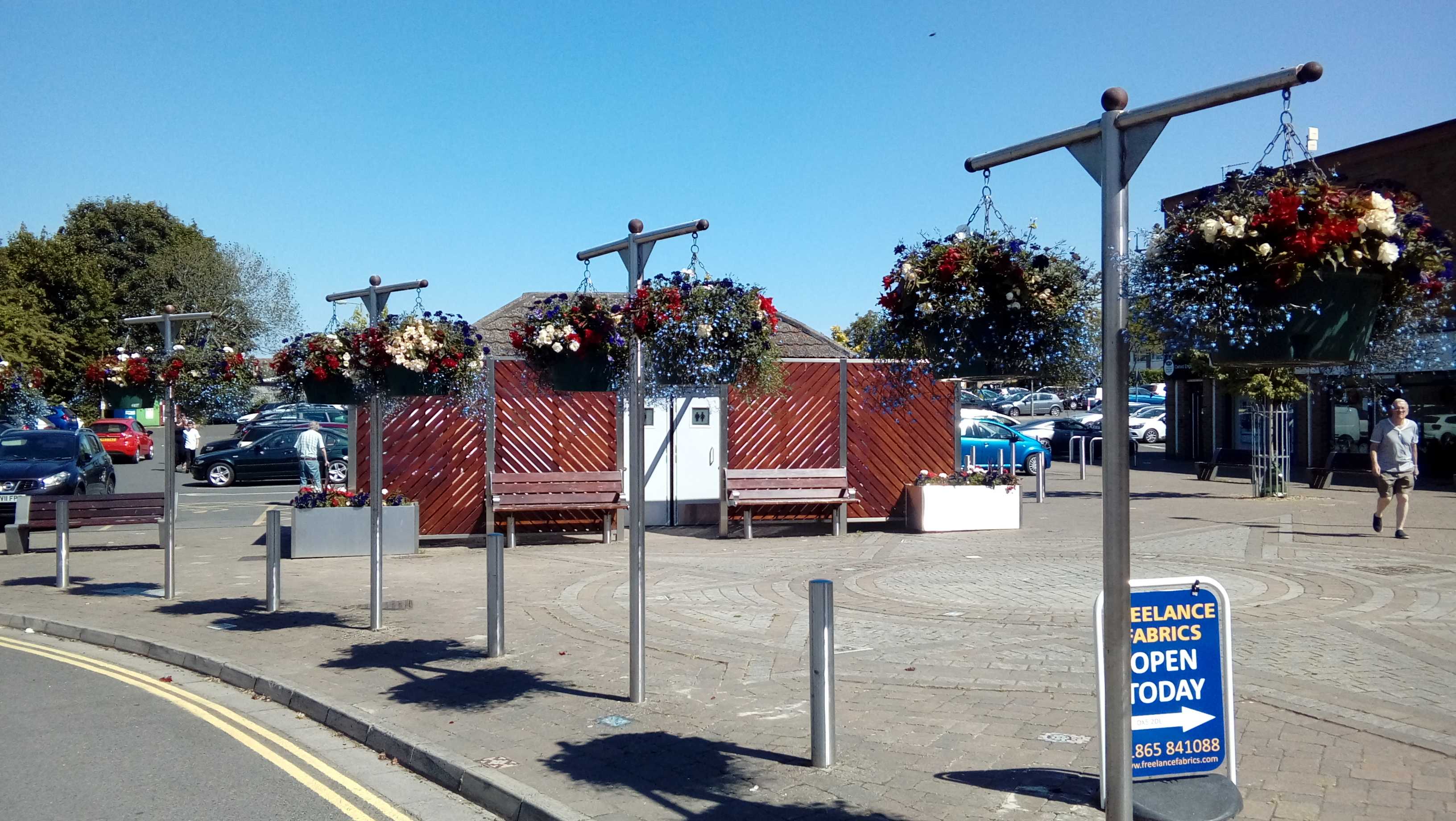 dark flowers hanging from baskets